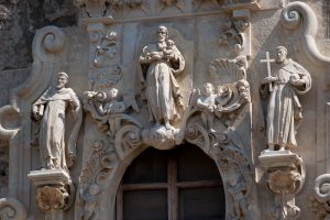 Statues of saints above front door to Mission San Jose church.